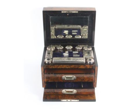 A mid Victorian figured walnut fitted travelling box of rectangular form brass lid plaque and escutcheon, the lid interior wi