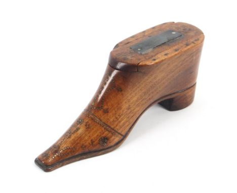 A large early 19th Century mahogany table shoe snuff box, decorated in brass pins, the toe with a thistle, the sliding lid wi