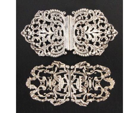 Two silver buckles a lady’s two part example each pierced and cast with leaves, jardinere, canopy and cherubs, London 1964, b