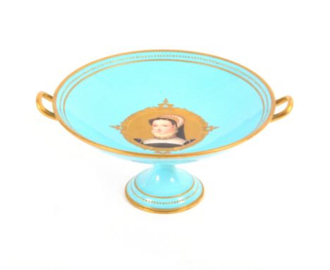 A Kerr & Binns tazza, late 19th century, of circular shape with loop handles and a pedestal foot, the turquoise ground reserv