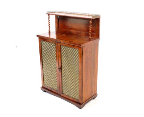 A mid-19th century mahogany chiffonier, the base enclosed by a pair of gilt brass trellis inset doors over a plinth base, the