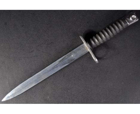 An original 20th Century Swiss 1957 pattern S.I.G rifle bayonet. Steel push release button to the pommel, ribbed plastic grip
