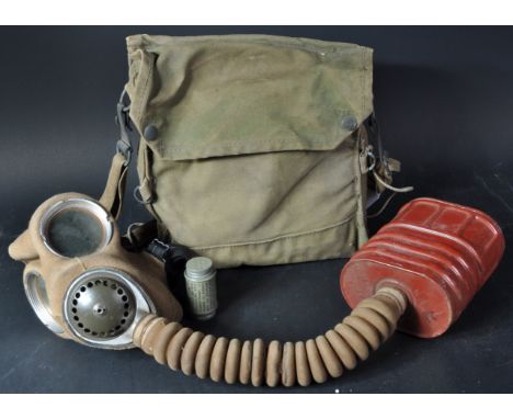 An original WWII Second World War British Army issued Service Respirator / Gas Mask. Fabric lined rubber mask with glass eye 