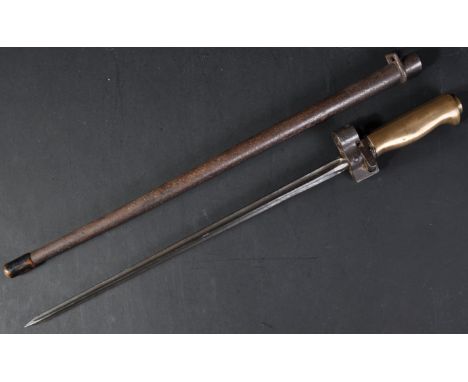 An original WWI First World War French Lebel Rifle ' Epee ' bayonet. The bayonet having a brass hilt, push release button to 