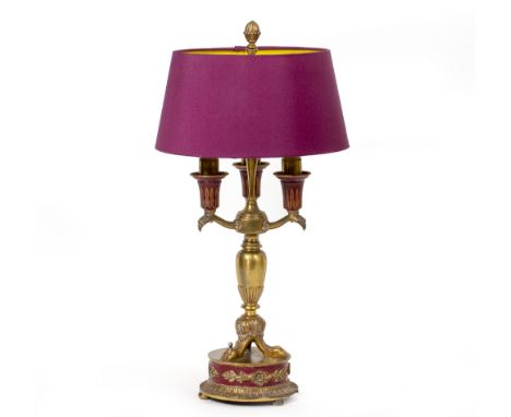 AN EMPIRE STYLE CAST BRASS THREE BRANCH TABLE LAMP with purple shade, 50cm high 