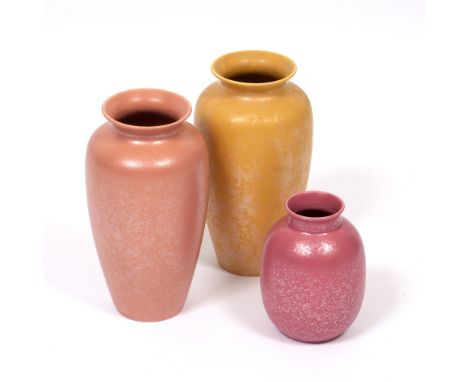 A MOTTLED YELLOW GROUND POOLE POTTERY VASE together with a mottled coral Poole Pottery vase and a smaller pink mottle glazed 