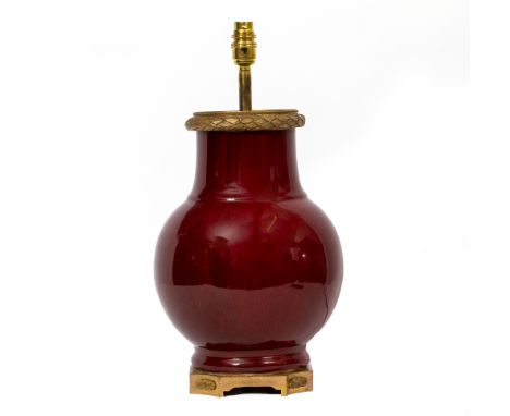 SANG DE BOEUF GLAZED TABLE LAMP with gilt metal mounts, 23cm wide x 45cm high