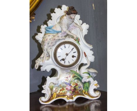 A 19TH CENTURY FRENCH PORCELAIN MANTLE CLOCK adorned with a maiden and a swan above a hand painted floral cartouche, the move