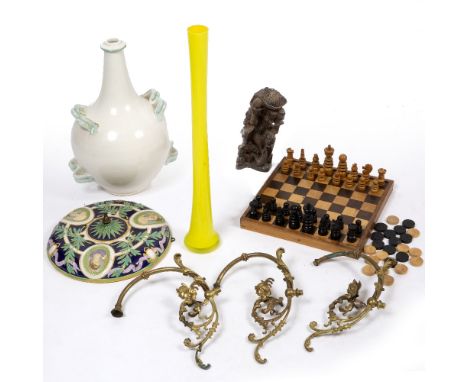 A TIN GLAZED BOTTLE VASE 44cm high, a tall slender yellow glass vase 59.5cm high, a Majolica plaque of a carved figural group