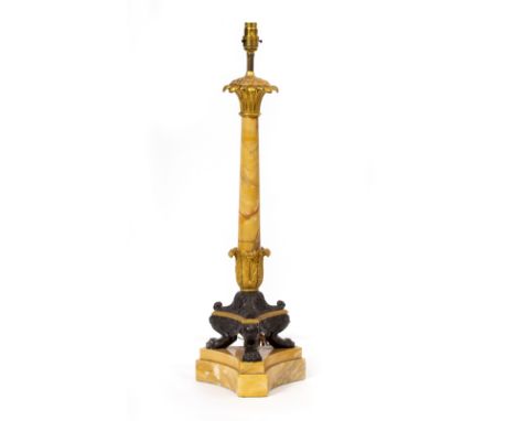 A TABLE LAMP with gilt brass and bronze mounts, in the form of a classical marble column with paw feet and triform base, 69cm