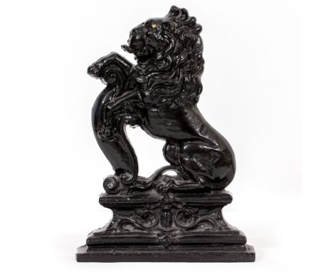 A CAST IRON STICK STAND with a pierced back, 36.5cm wide x 23cm deep x 75cm high and a plated cast iron door stop in the form