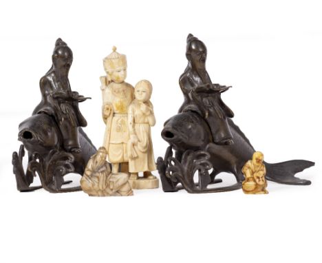 TWO SIMILAR CAST BRONZE SCULPTURES of wise men riding on the back of carp together with an antique Indian marine ivory sculpt