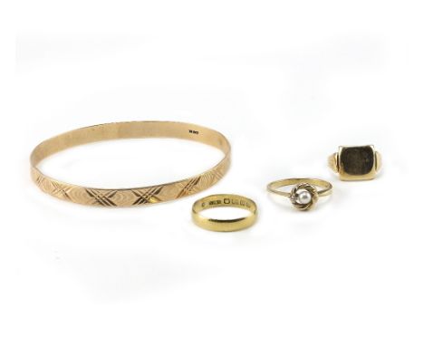 A YELLOW METAL PEARL SET RING, an 18ct gold ring, a yellow metal signet ring and an Eastern yellow metal bangle