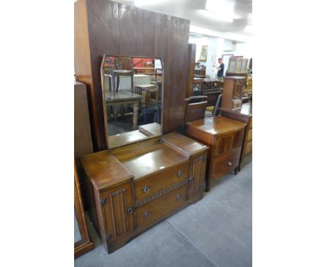 A George III bow front inlaid mahogany commode and an oak dressing table 