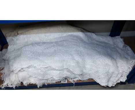 A vintage lace bedcover and other bedcover's and throws.