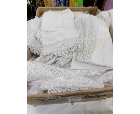 A box of vintage lace and table linen.