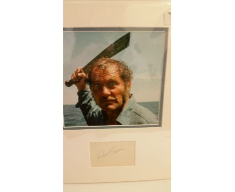 CINEMA, Jaws, signed album page by Robert Shaw, overmounted beneath colour photo, h/s wielding machete, in scene from Jaws, 1