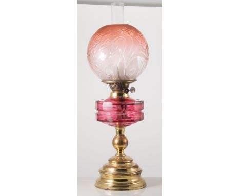 Victorian oil lamp, moulded red tinted Art Nouveau shade, brass pedestal, 59cms.
