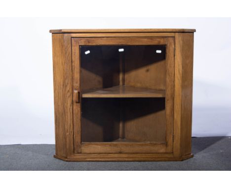 Oak wall mounted corner cabinet, with glazed door revealing single shelf, 77cms wide, 71cms high.