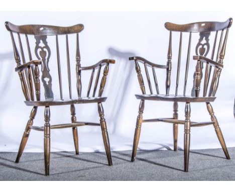 A pair of modern elbow chairs, and two beech stick-back kitchen chairs.