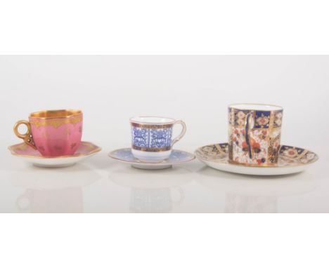 Miniature Coalport cabinet cup and saucer, gilt decoration on a pink ground, height overall 5cm, a Worcester cabinet cup and 