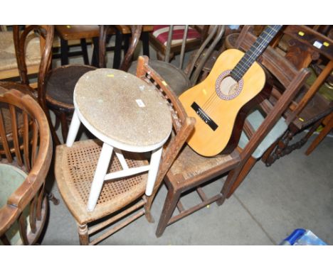 A cane seated chair together with a white painted stool and an oak ladder back chair 