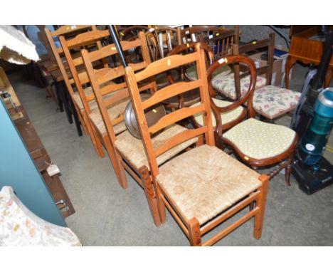 A set of four pine ladder back chairs 
