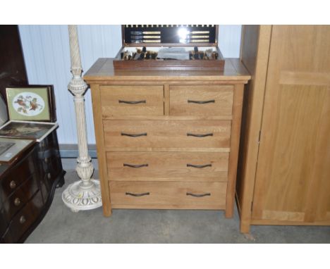 A light oak chest fitted two short over three long drawers 
