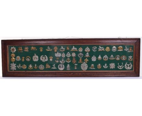 Framed Display of Regimental Cap Badges, mostly of WW1 vintage, including Royal Scots, Queens West Surrey, East Kents, The Ki