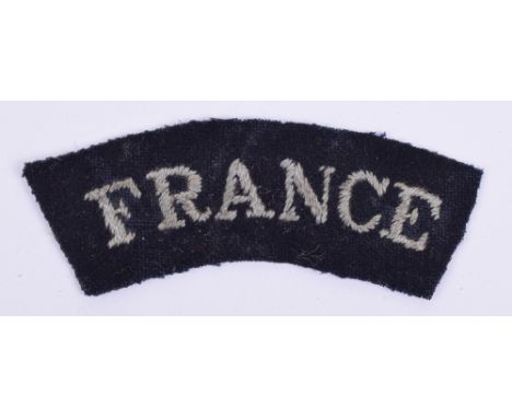 WW2 Royal Air Force France Nationality Cloth Shoulder Title, embroidered example on dark blue / black cloth. Paper residue to