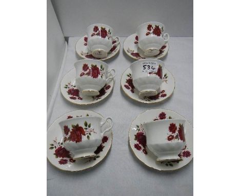 A set of six tea cups and saucers.