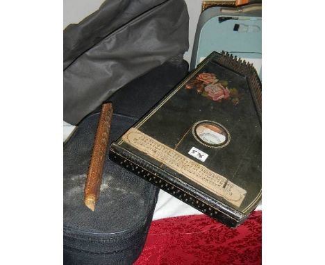 A violin case, a soft case German harp and an early wooden recorder.
