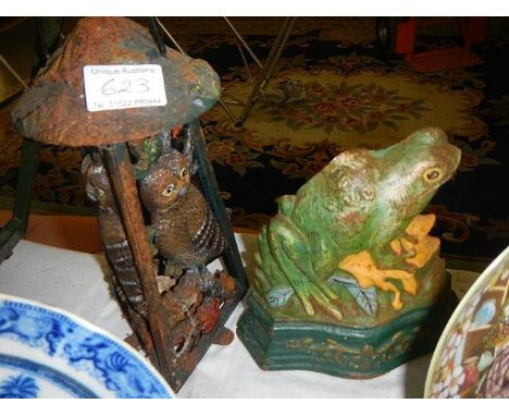 A cast iron frog doorstop and one other item.