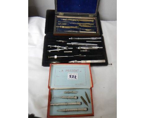 Two part geometry sets and a pen set.