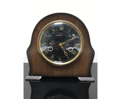 An oak cased Smith's mantel clock