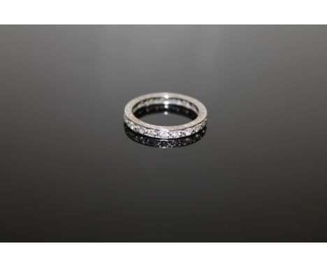 A white metal diamond full eternity ring, size K/L. CONDITION REPORT: There is no visible hallmark. In my opinion this would 