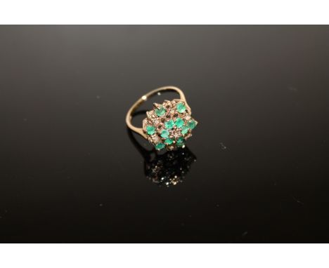 A 9ct gold emerald and diamond cluster ring, size N CONDITION REPORT: 3.2g. In good condition with no apparent faults. 