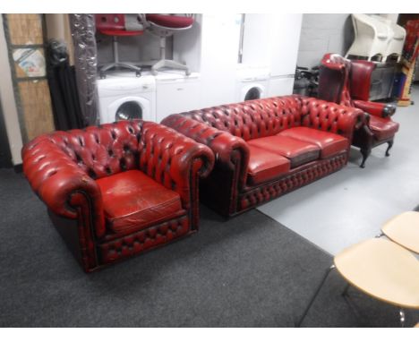 A three piece red button leather Chesterfield suite, comprising three seater settee, club armchair and wingback armchair (Win