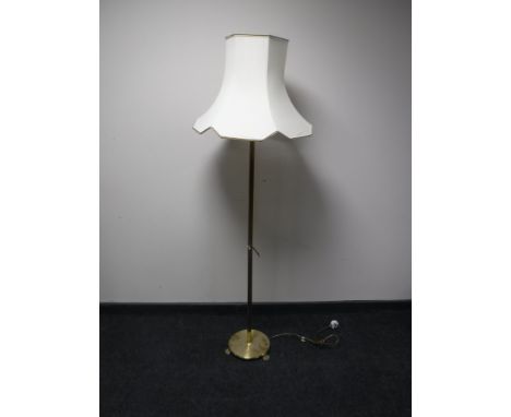 A brass column standard lamp and shade 
