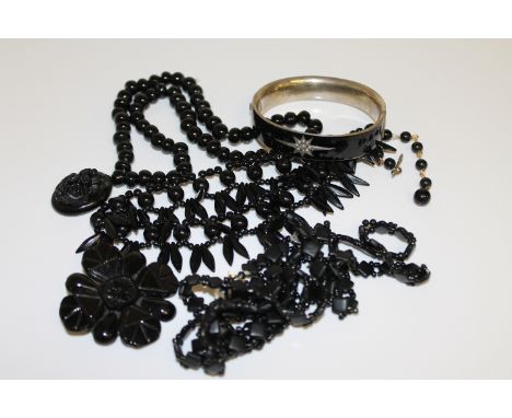 Three jet necklaces, a brooch and a seed pearl set enamel bangle (5) CONDITION REPORT: Bangle with minor scuffs and scratches