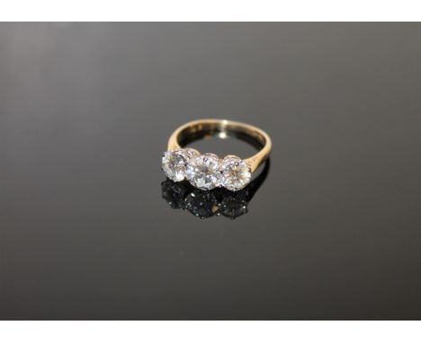 A fine quality three stone diamond ring, the total diamond weight estimated at 2.10 carats, size N