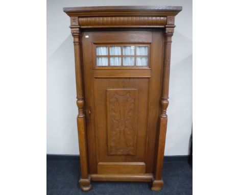 A continental oak cabinet with pillar supports 