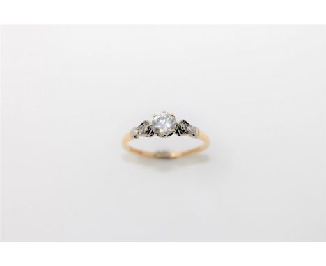 An 18ct gold solitaire diamond ring, the principal brilliant cut stone weighing an estimated 0.6 carat, with diamond set shou