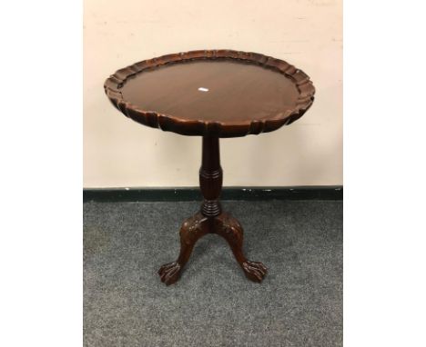 A reproduction mahogany pedestal occasional table