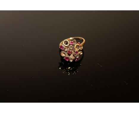 A 9ct gold ruby cluster ring, size L CONDITION REPORT: 4.8g. Very minor abrasions to the stones when viewed under magnificati