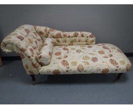 A button back chaise lounge in floral fabric 