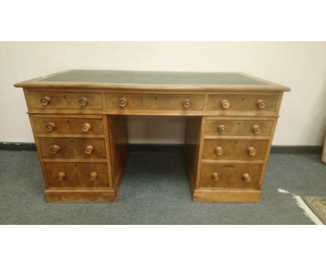 A late Victorian walnut twin pedestal writing desk, width 137 cm. CONDITION REPORT: Back panel missing.
