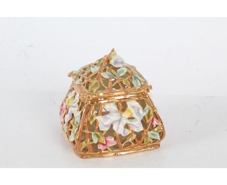 Zsolnay porcelain pot and cover, with a pierced foliate decoration in blue and red on a gold ground, 10cm diameter by 10cm hi