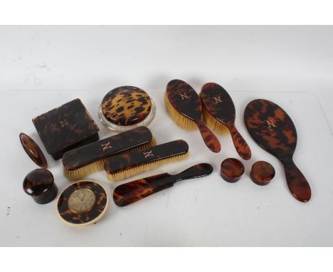 A good set of 20th century faux tortoise shell dressing table set with the letter N in yellow metal, consisting of two hair b