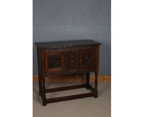 A 17th century style sideboard, the rectangular top above a flower filled carved lunette frieze, together with two cupboard d